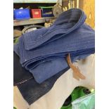 Box cloth coaching rug together with a pair of blue aprons and a dark blue apron