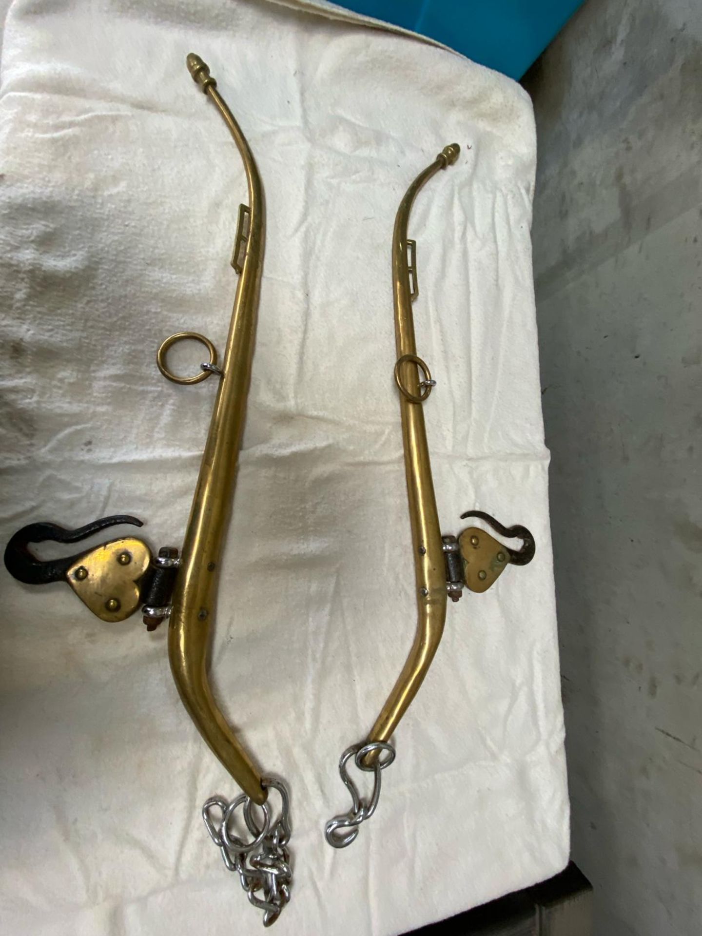 Pair of brass hames with hooks.