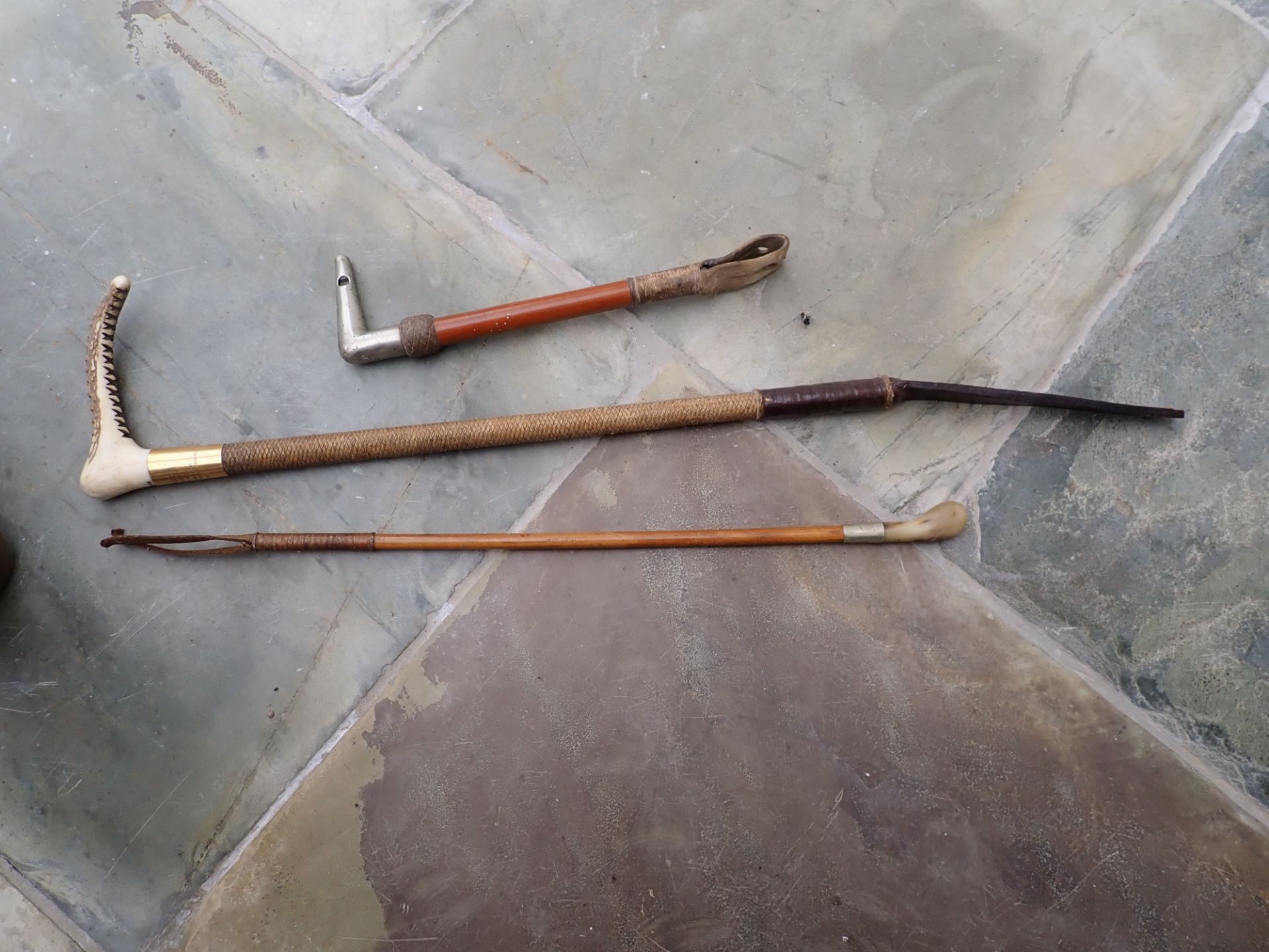 Hunting whip by Brigg; Vintage lady's whip by Swayne and a small whistle whip.