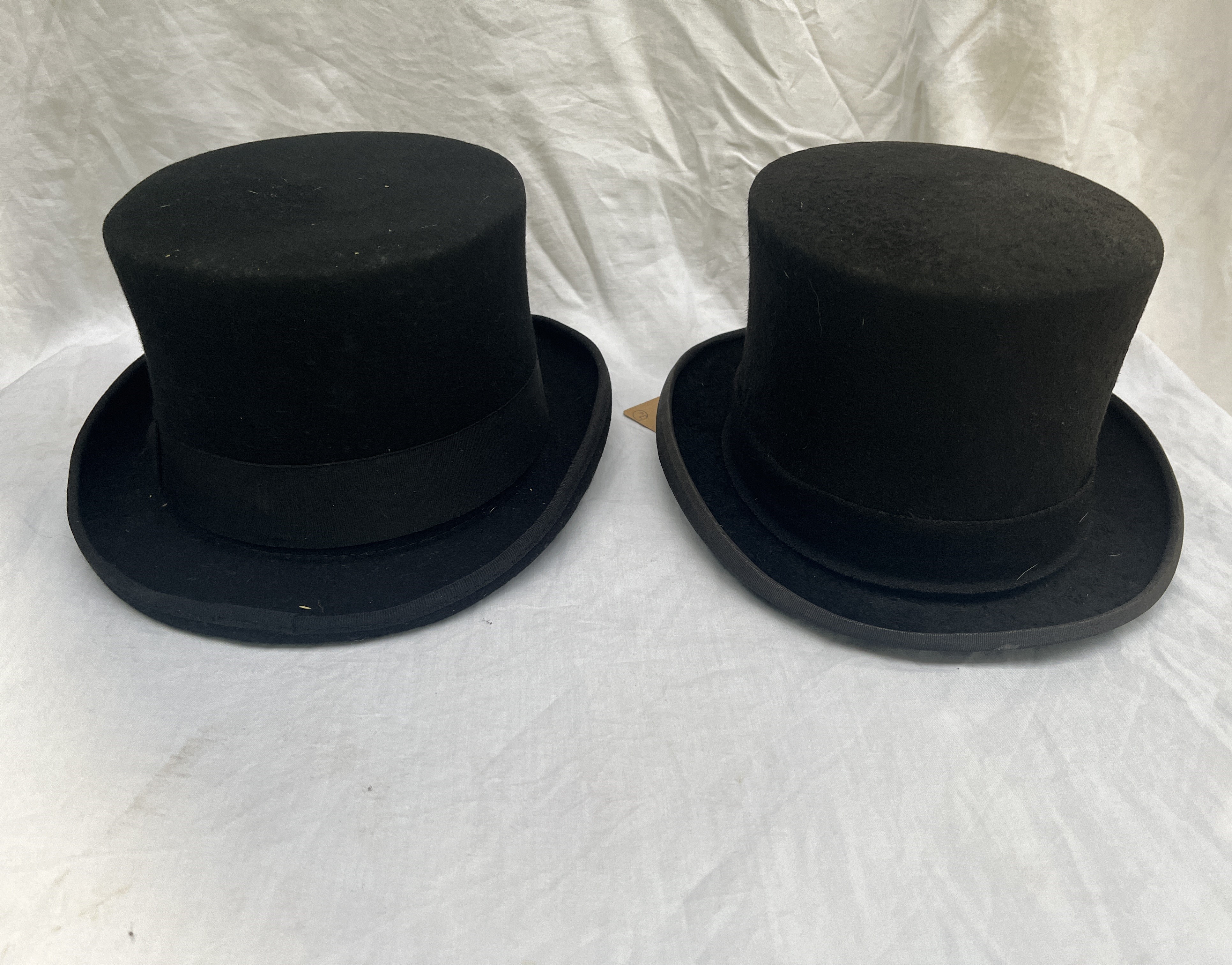 Three black top hats; large and two 7"