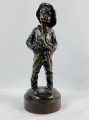 Bronze figure of a boy with hands in his pockets, signed to base L Kley