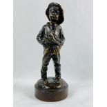 Bronze figure of a boy with hands in his pockets, signed to base L Kley