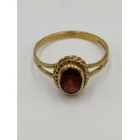 9ct gold ring set with a red stone