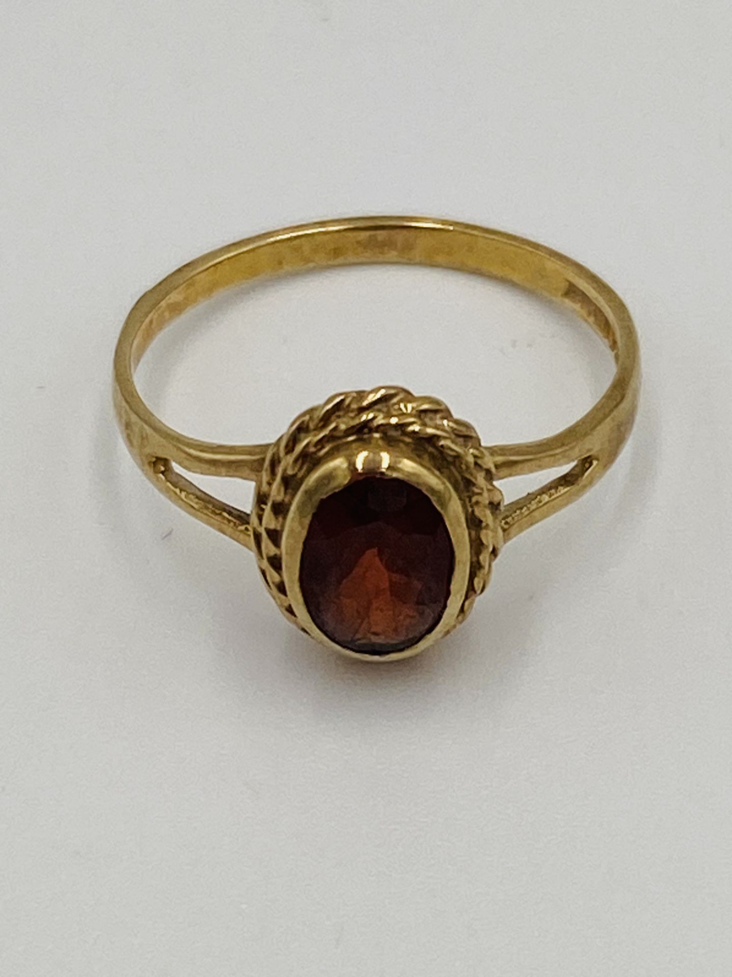 9ct gold ring set with a red stone