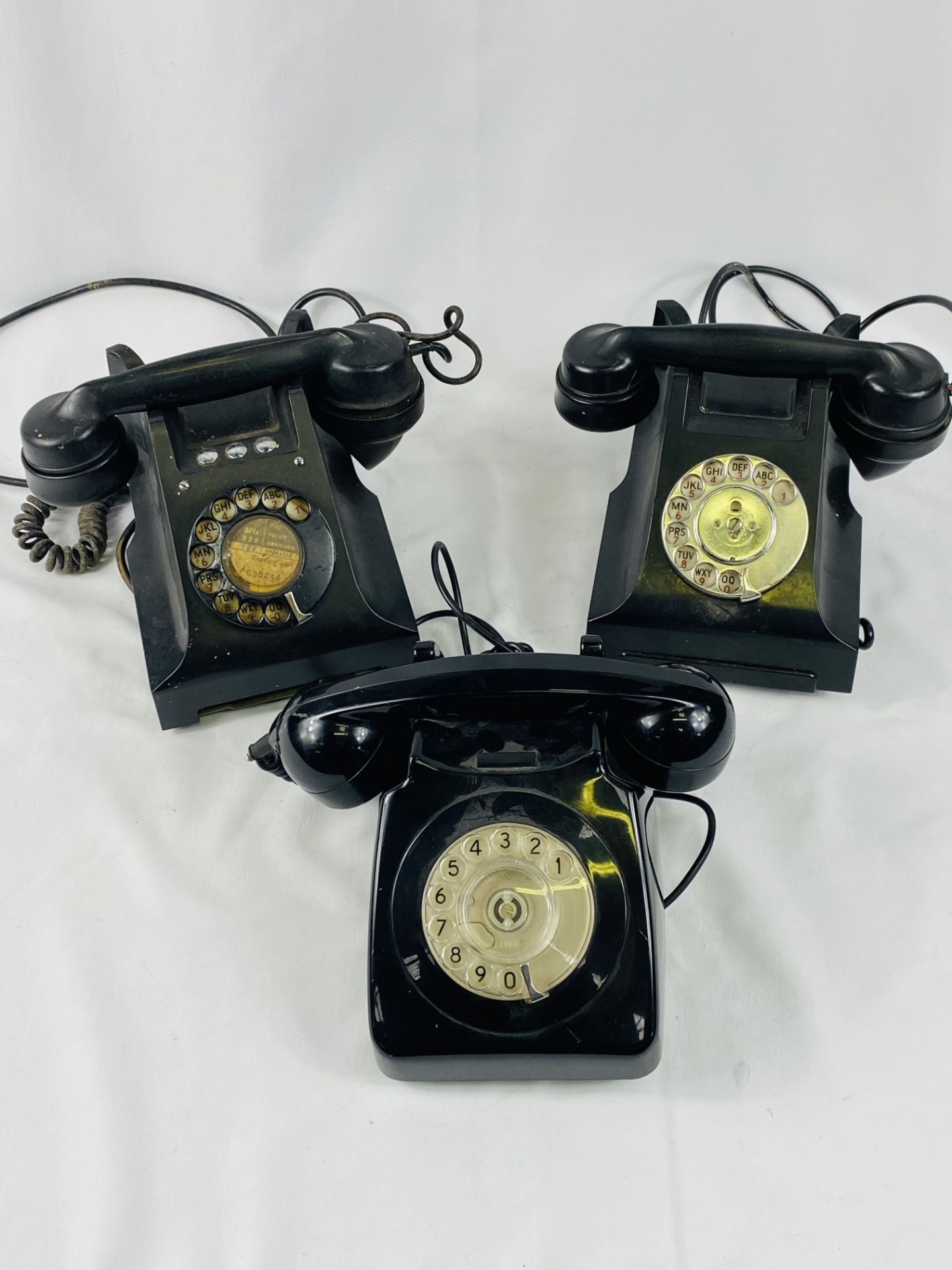 Three black bakelite telephones