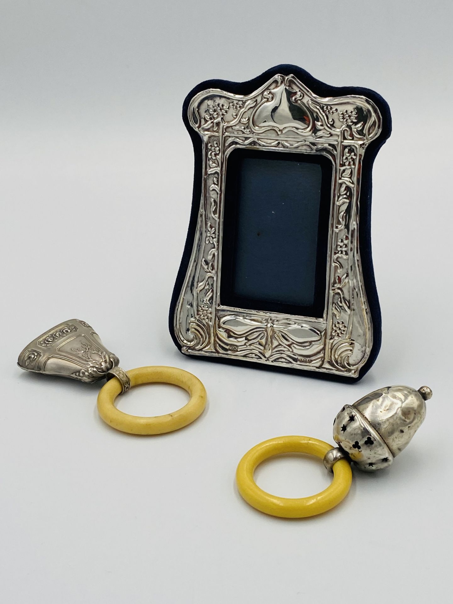 Silver mounted photograph frame; together with two silver baby rattles - Image 3 of 4