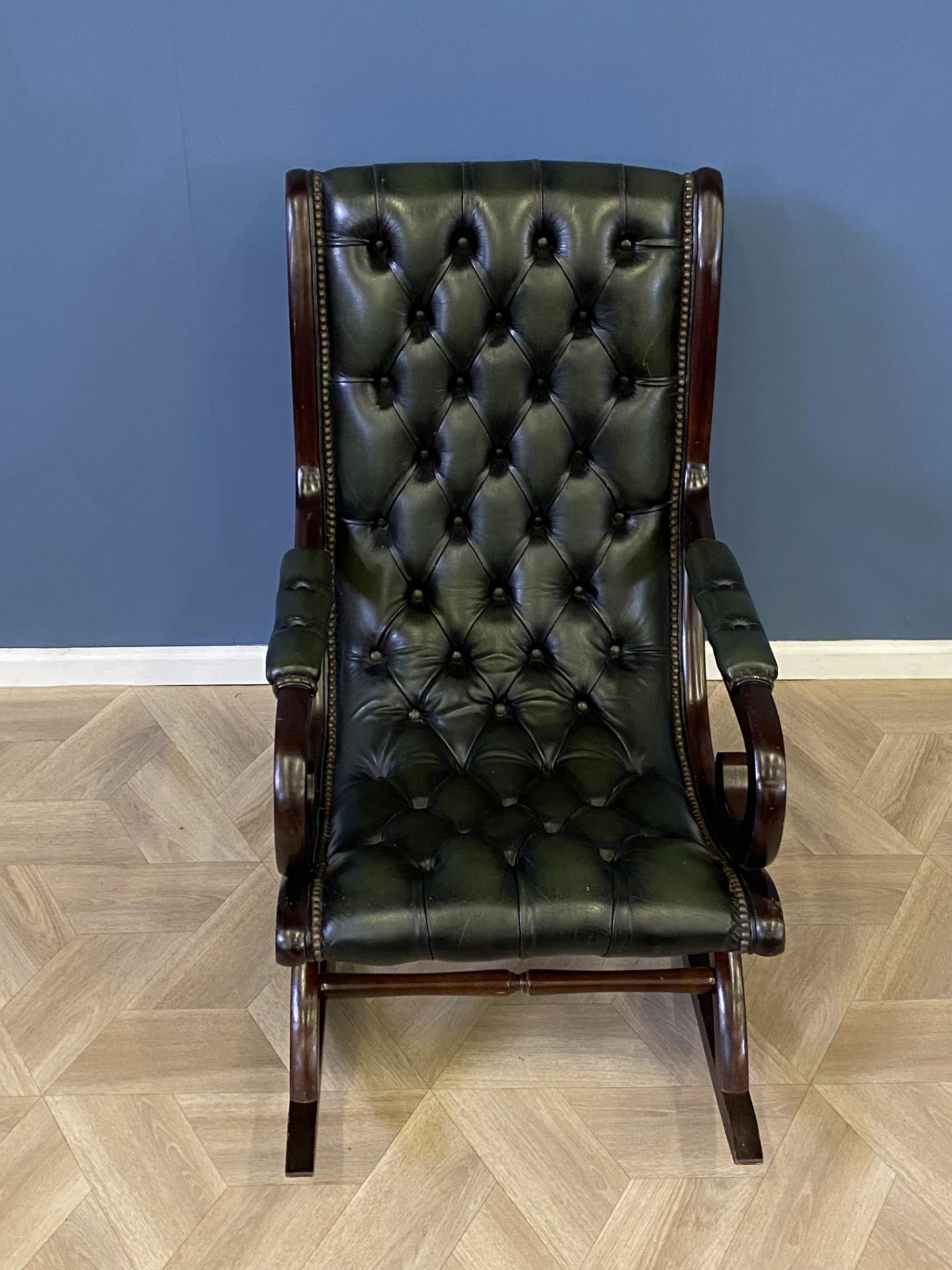 Mahogany framed green leather button back rocking chair