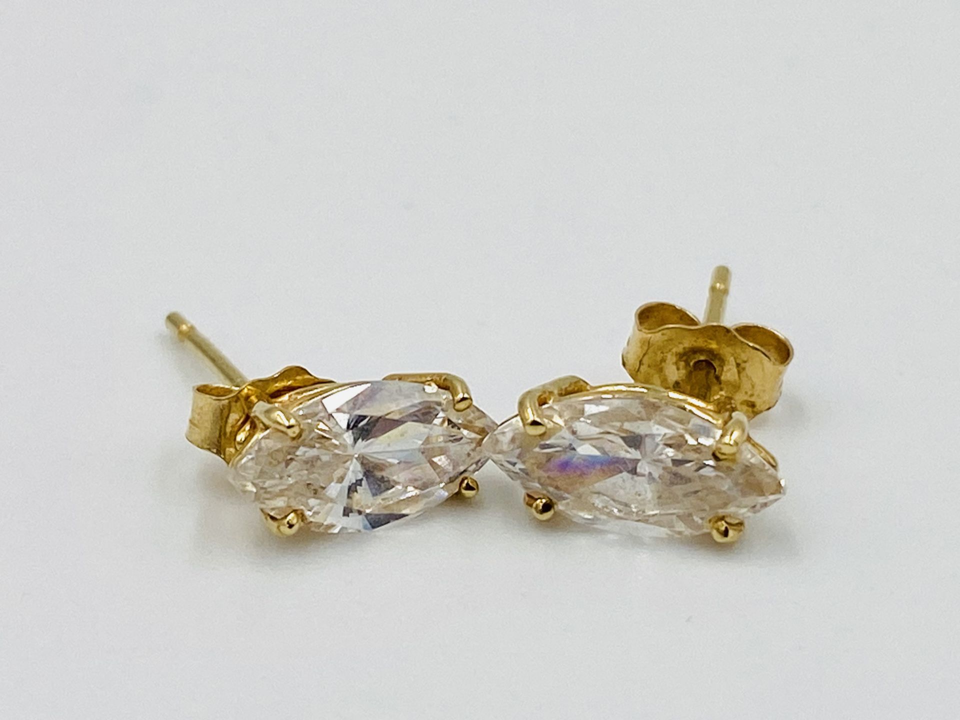 Pair of 14ct gold earrings set with a white stone