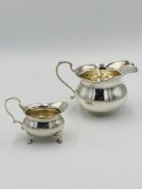 Two silver milk jugs