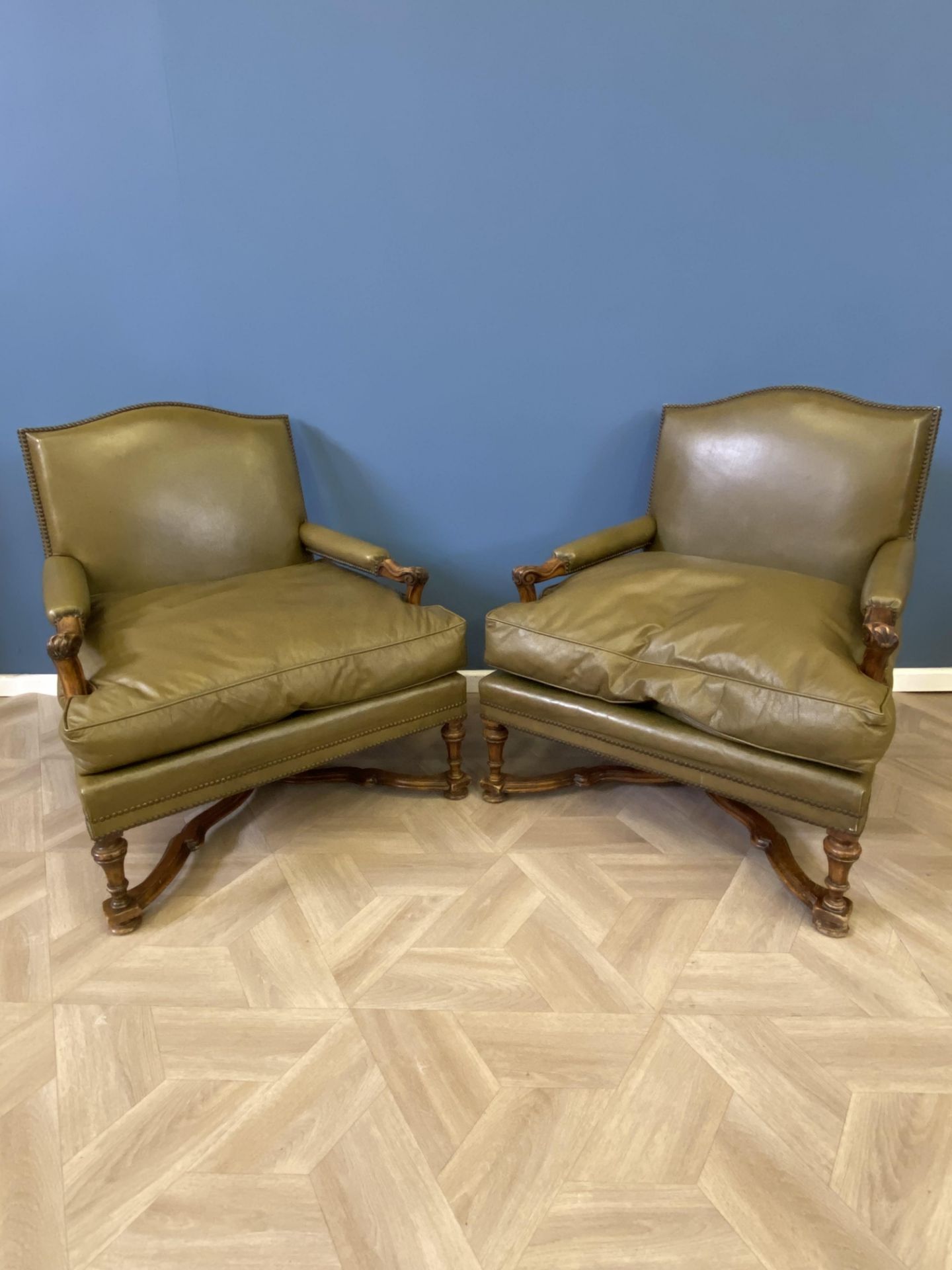 Pair of green leather armchairs