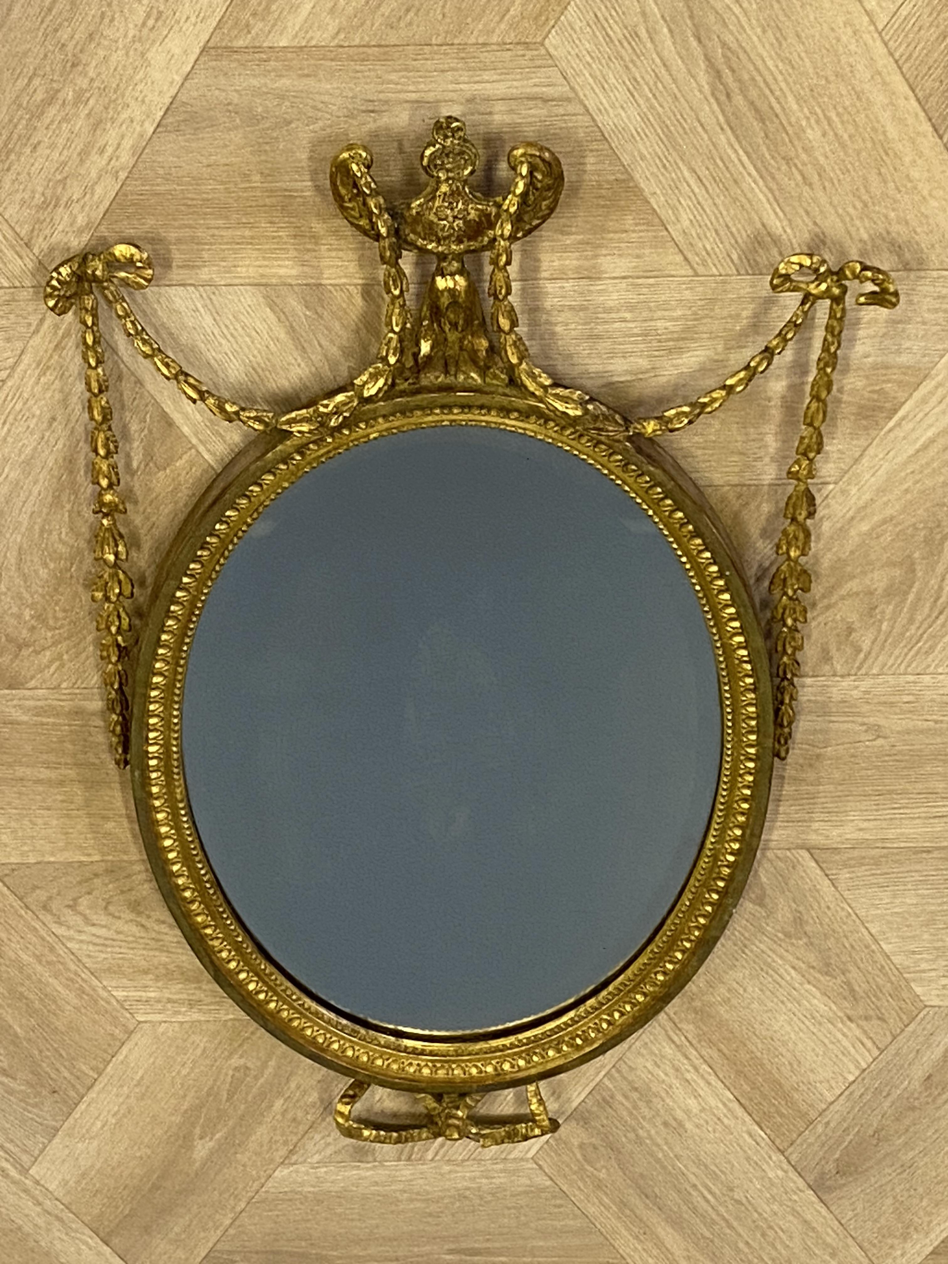 Antique oval Adam style mirror