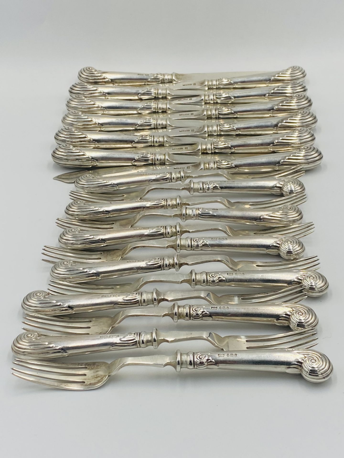 Twelve place set of silver pistol grip fish knives and forks, London 1905