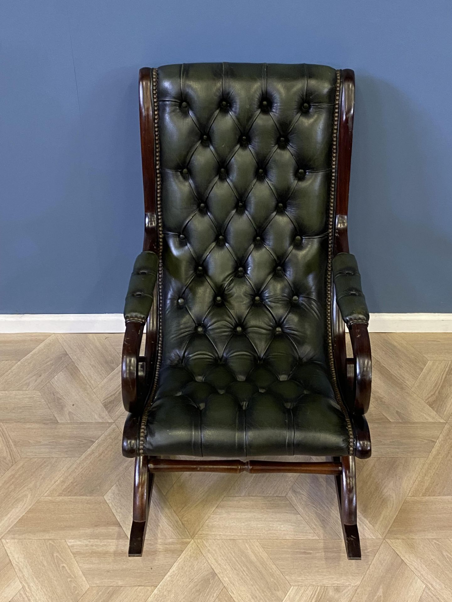 Mahogany framed green leather button back rocking chair