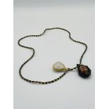 Bead necklace with pendant depicting a reclining Buddha and a 'Bia Kae' pendant.