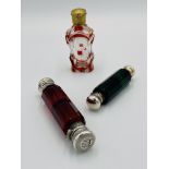 Three scent bottles with silver tops.