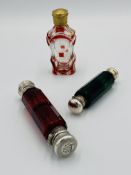 Three scent bottles with silver tops.