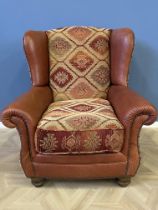 Contemporary leather and fabric upholstered armchair