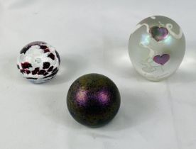 Three glass paperweights