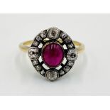 Gold ring set with a centre ruby and diamond surround