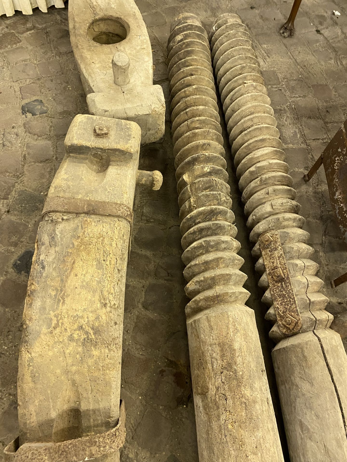 Two threaded wood uprights and bases from a fruit press