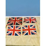 Four Union Jack flags on poles