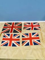 Four Union Jack flags on poles