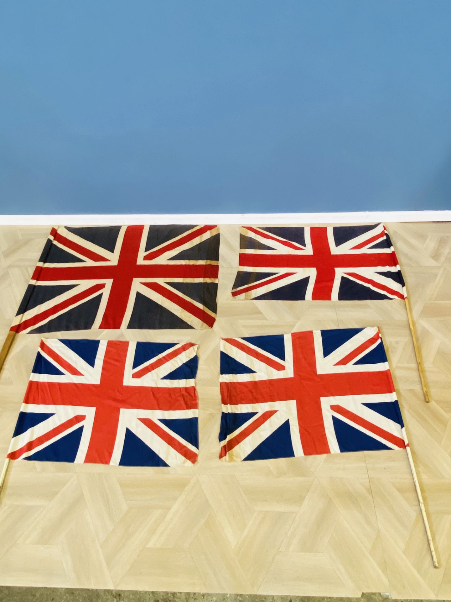 Four Union Jack flags on poles