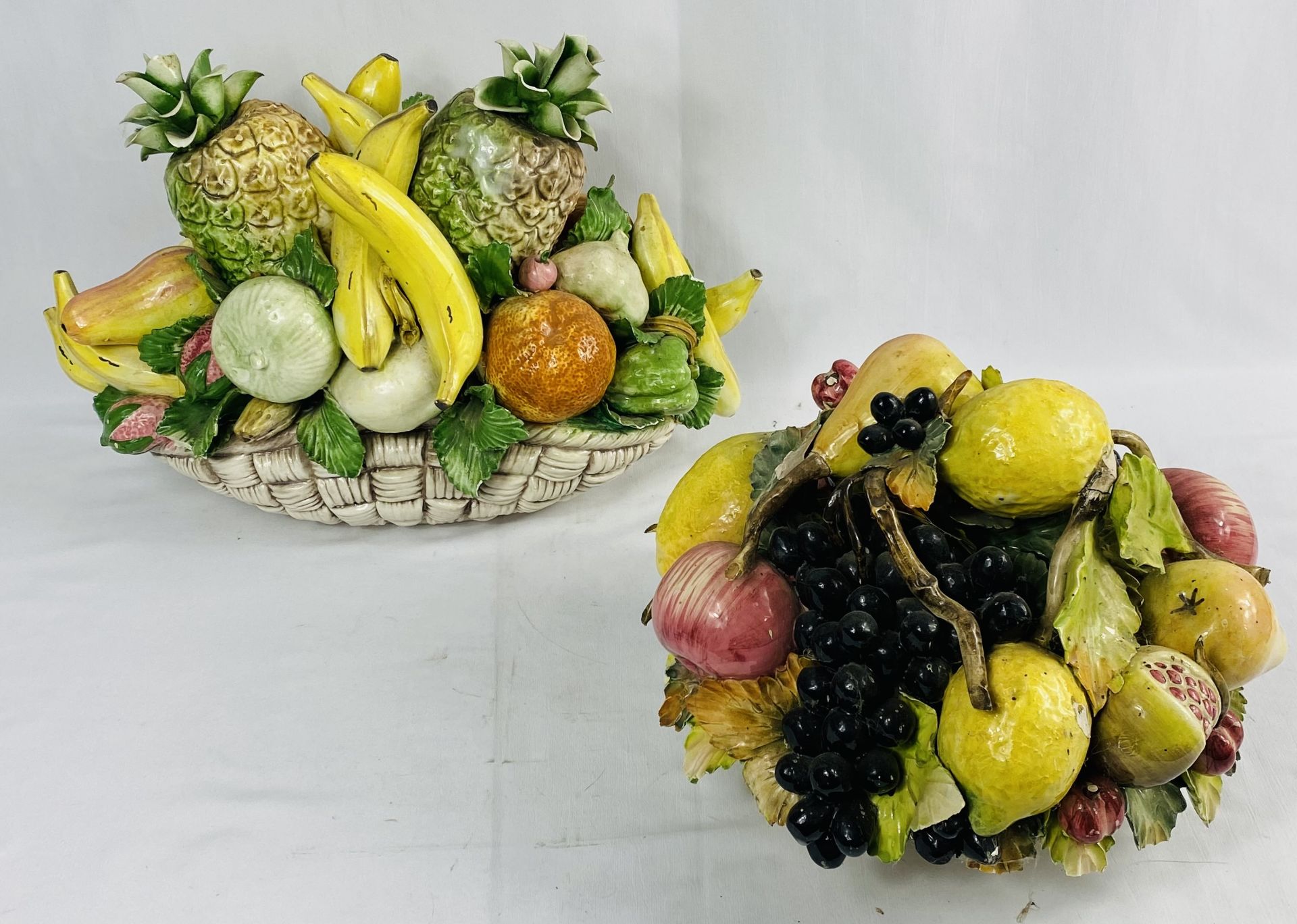 Capodimonte basket of fruit together with a ceramic basket of fruit