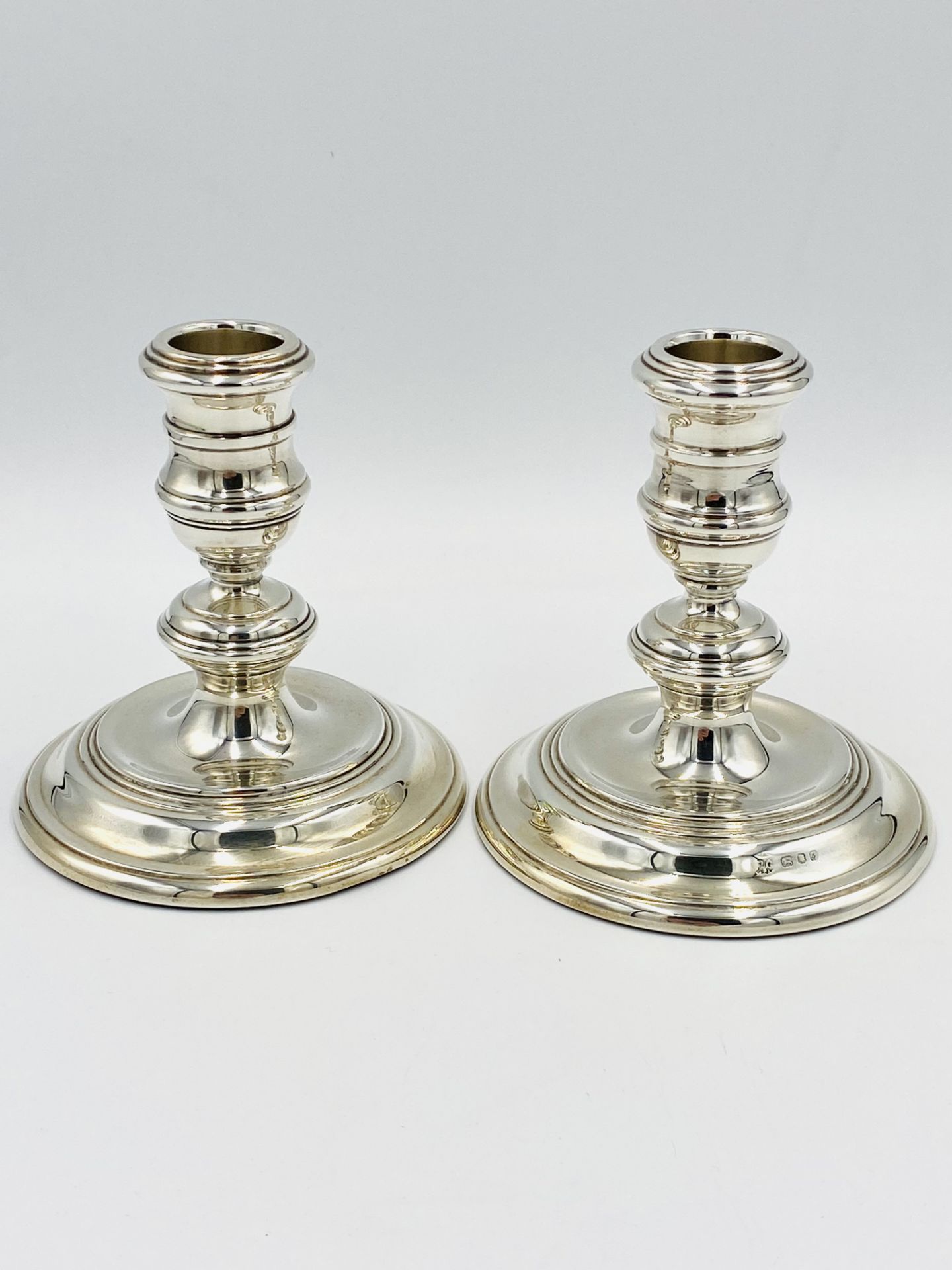 Pair of weighted silver candlesticks