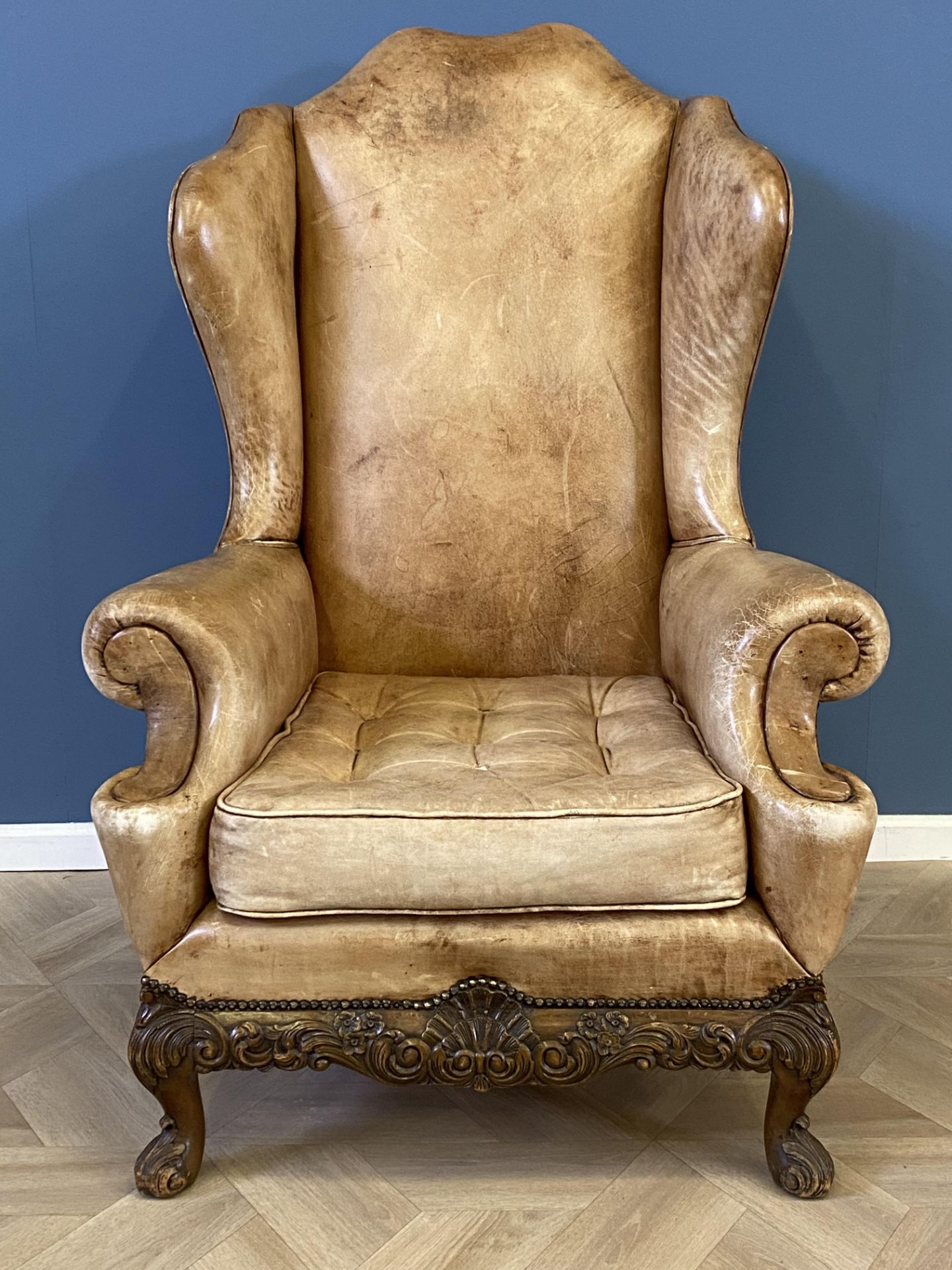 Queen Anne style leather wing back open armchair