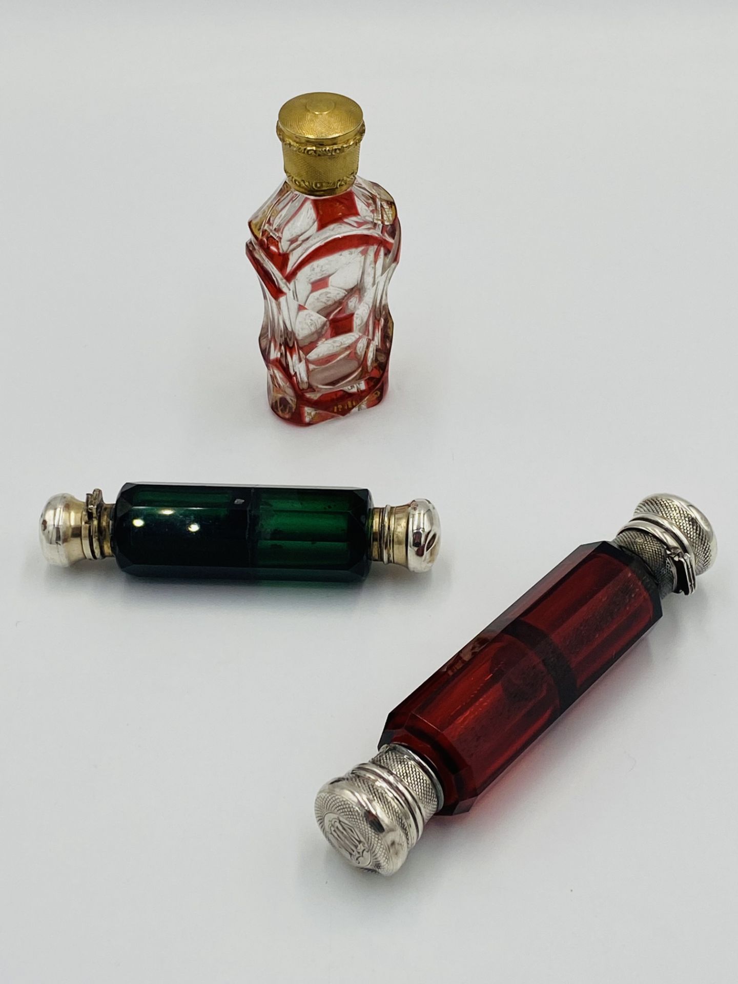 Three scent bottles with silver tops. - Image 2 of 5