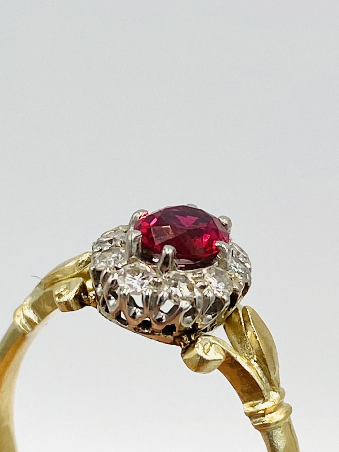 Gold ring set with central ruby and diamond surround - Image 2 of 6