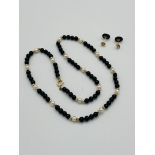 Bead necklace with 9ct gold clasp,together with matching earrings