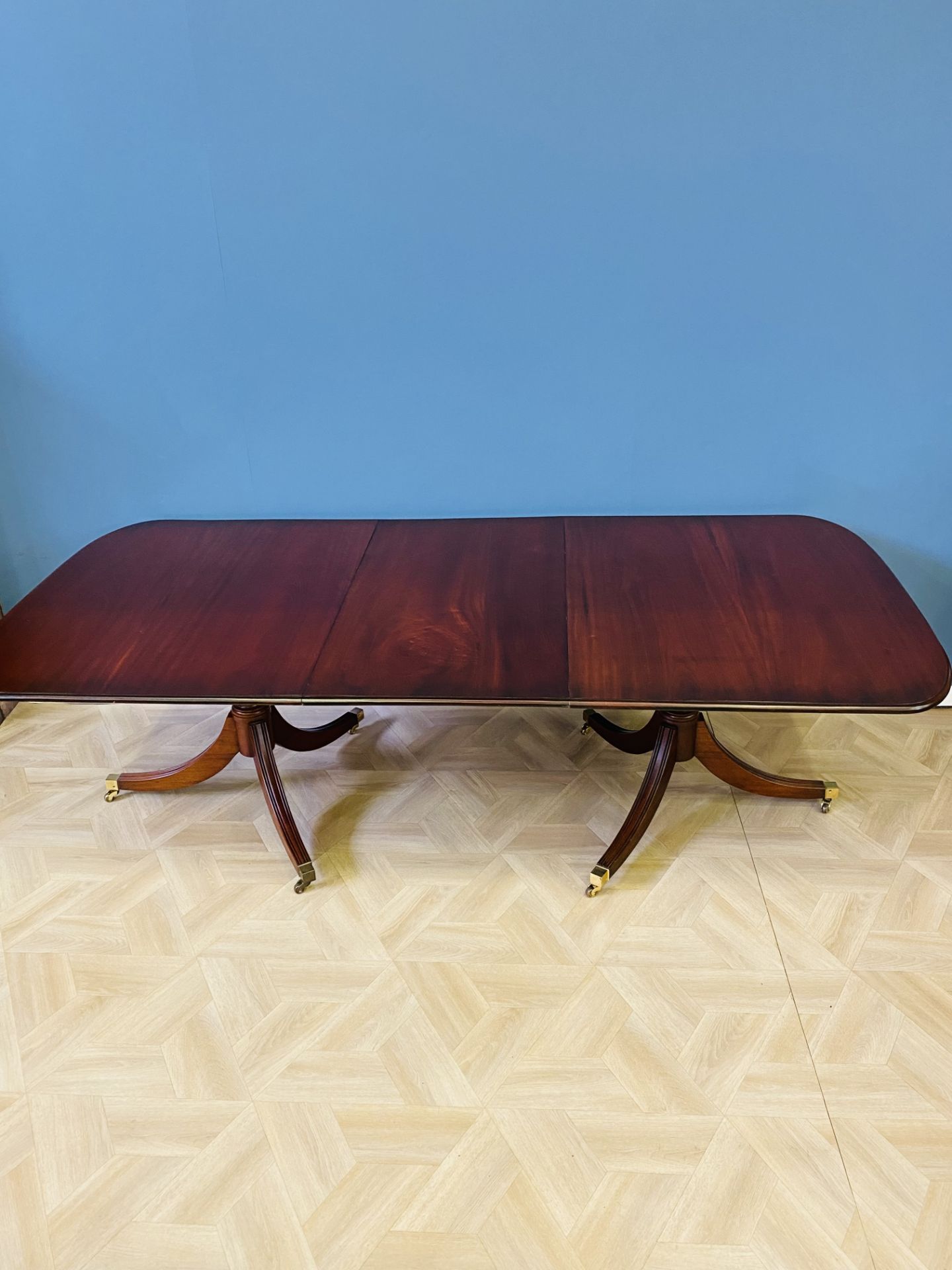 Regency style mahogany twin pillar dining table