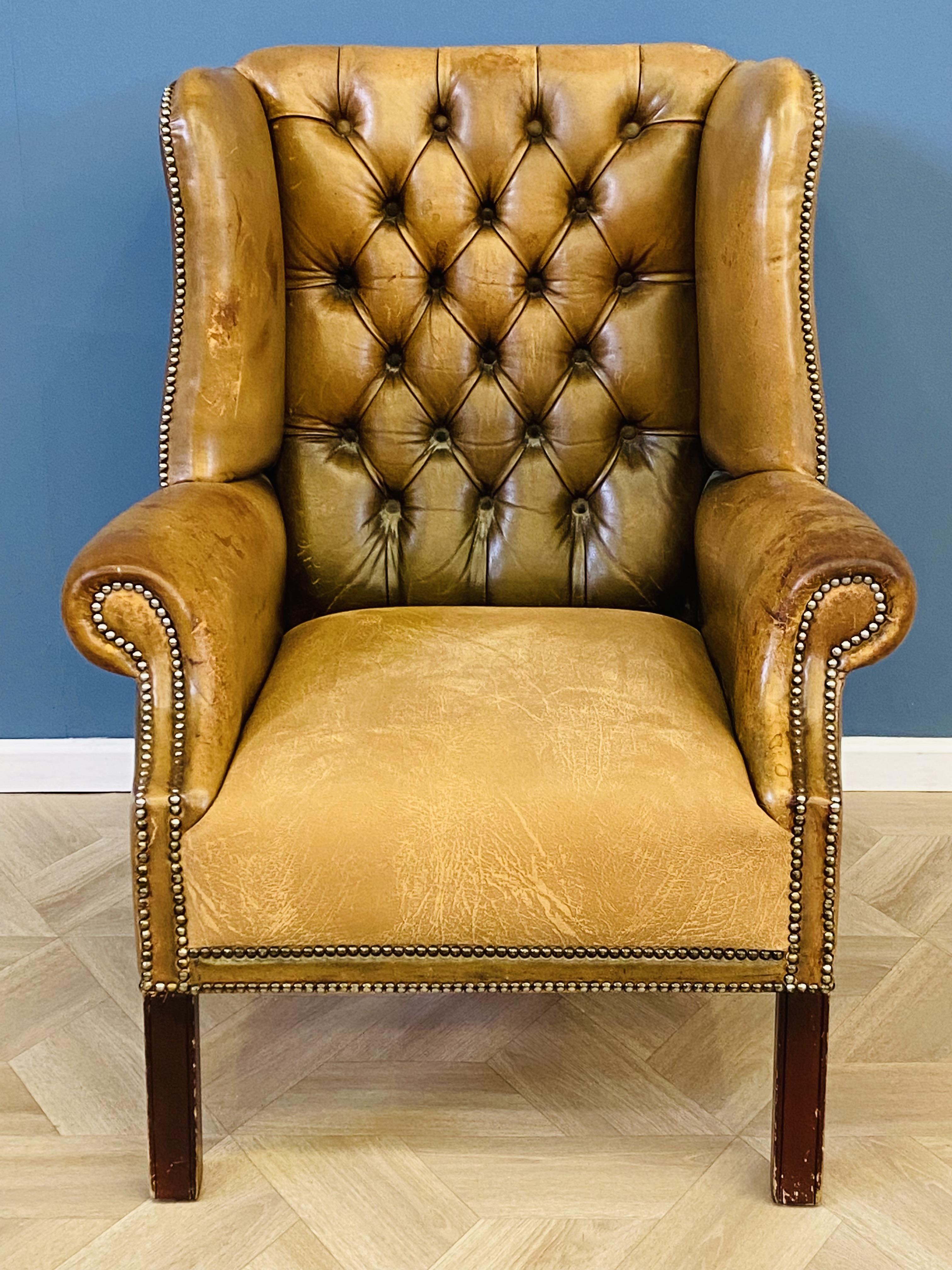 Leather button back wing armchair