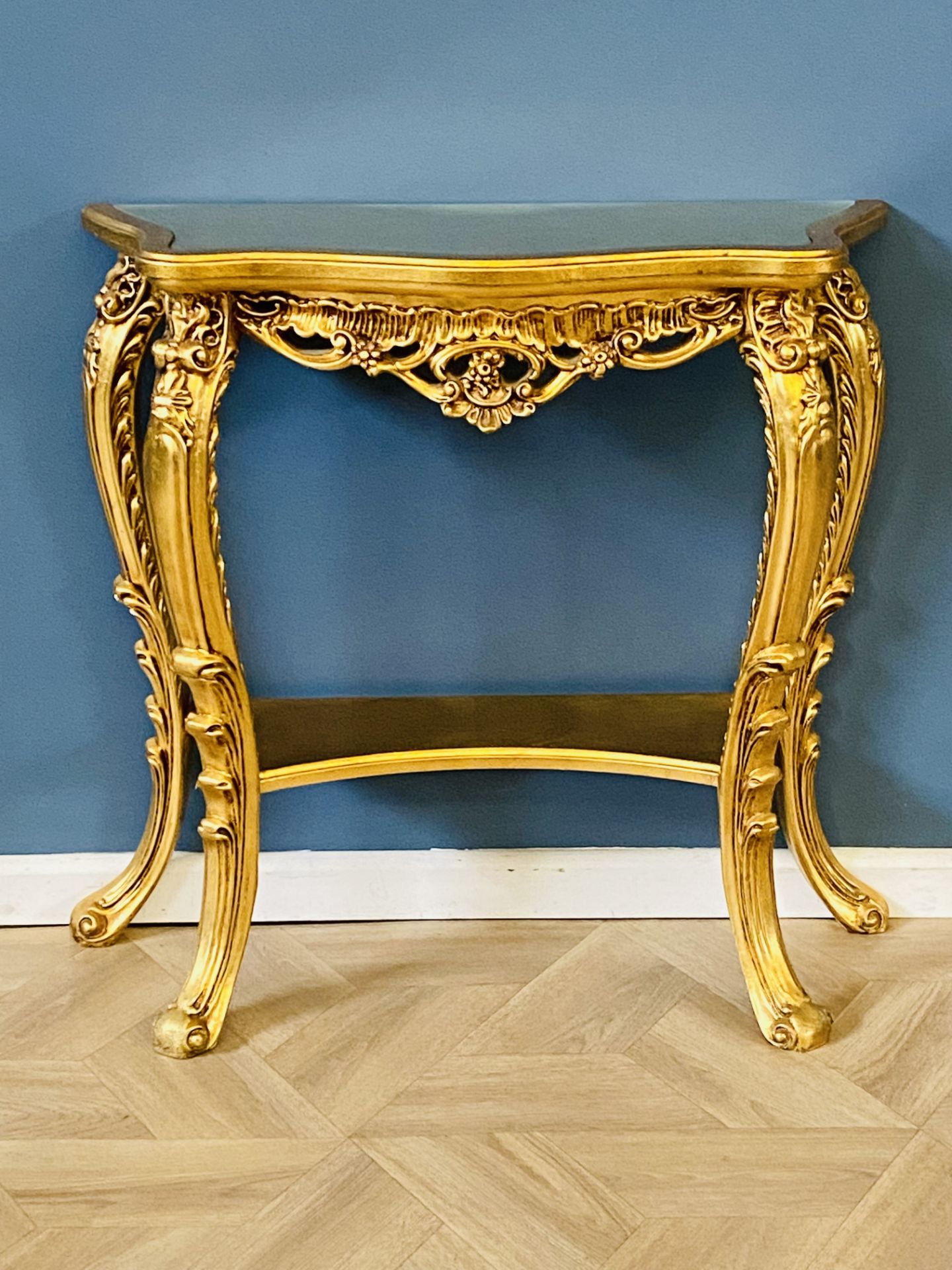 Serpentine carved giltwood console table