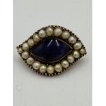 Pearl brooch with purple centre stone