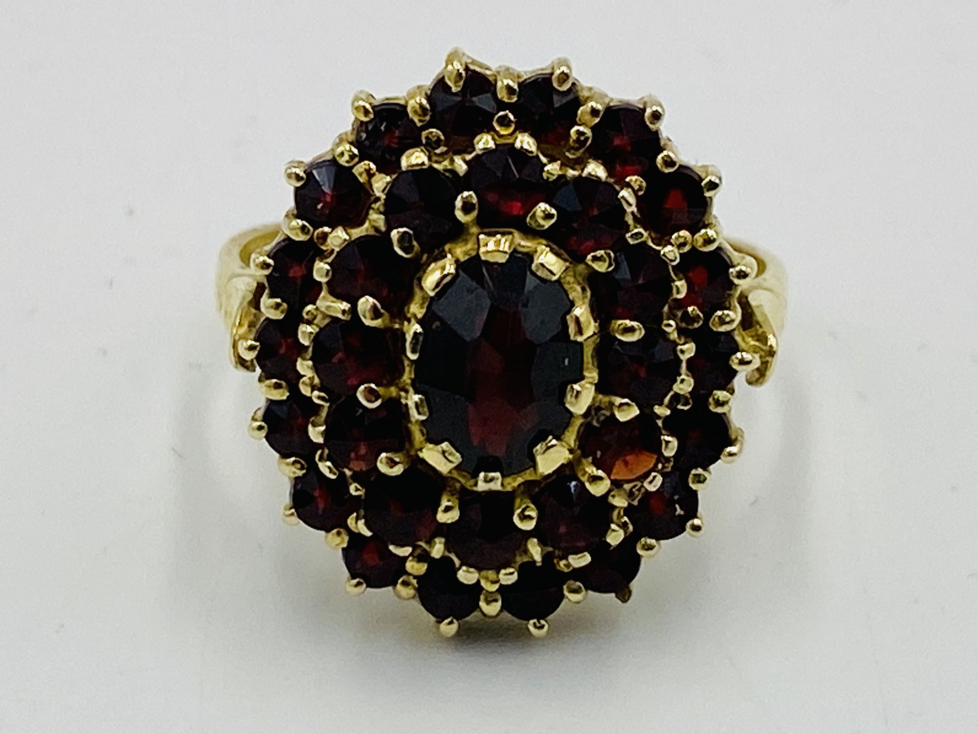Yellow metal ring and red stone ring