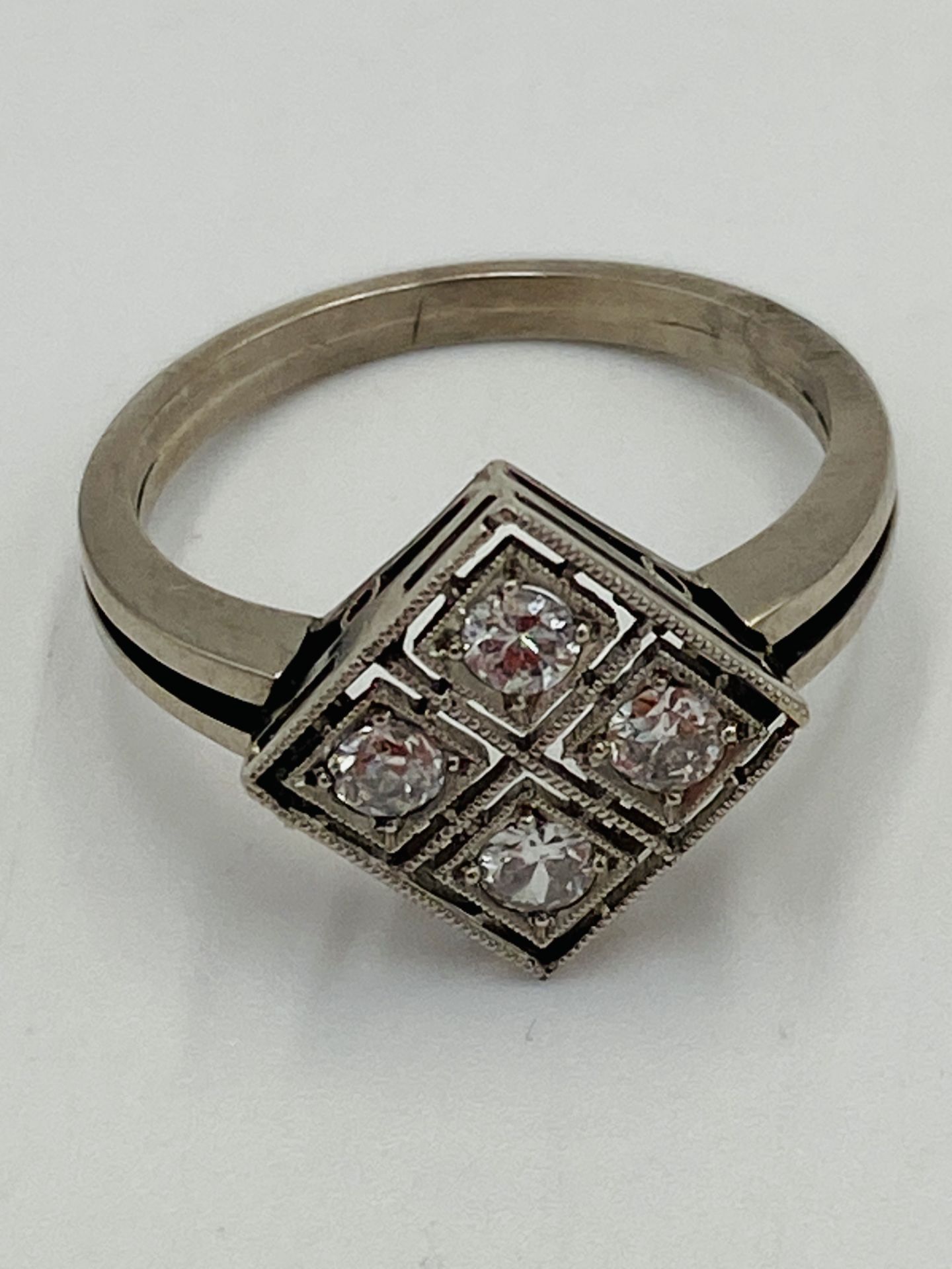 White gold ring set with four diamonds