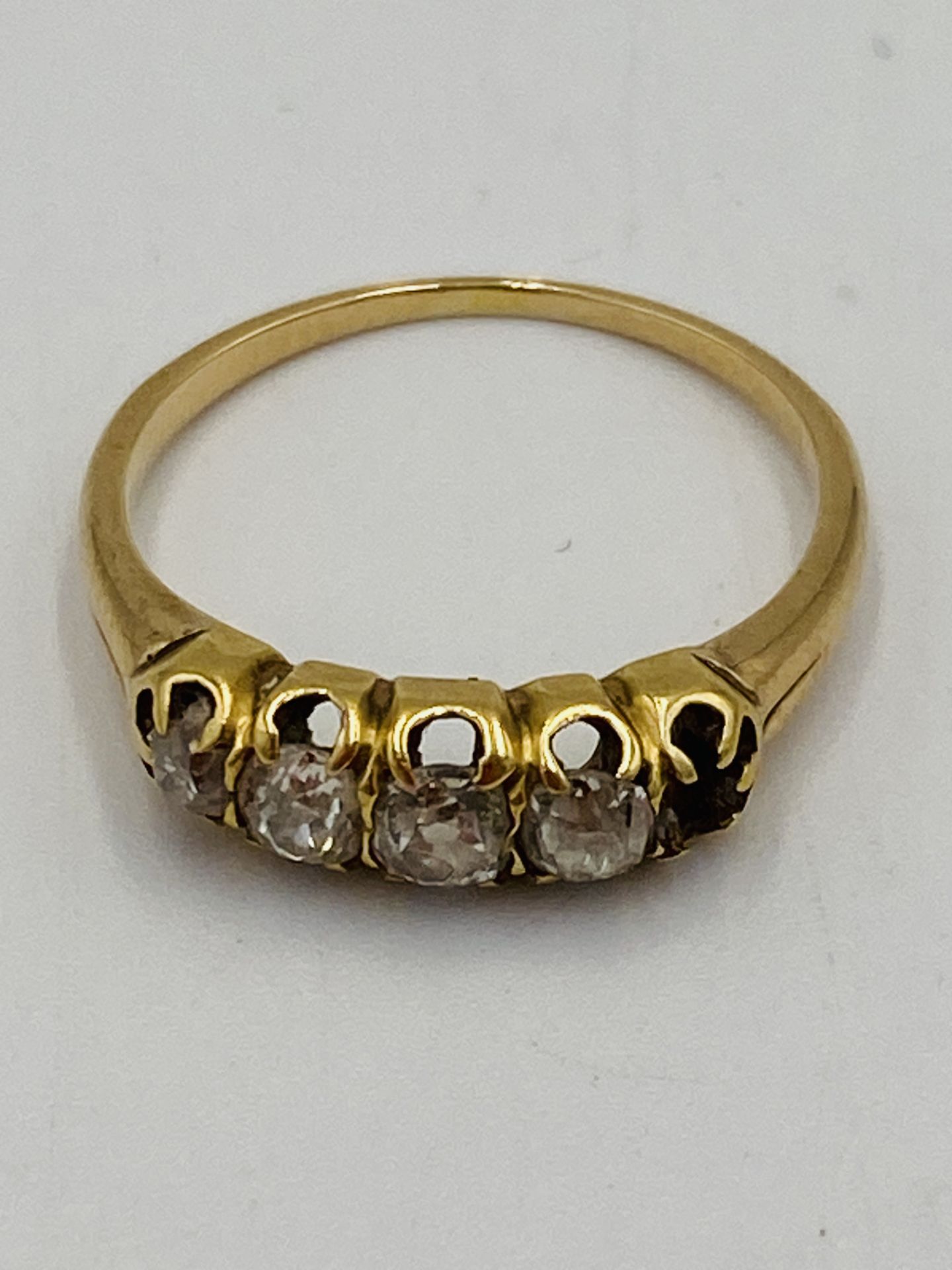 Gold ring set with four diamonds