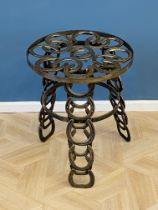 Steel occasional table constructed from horseshoes