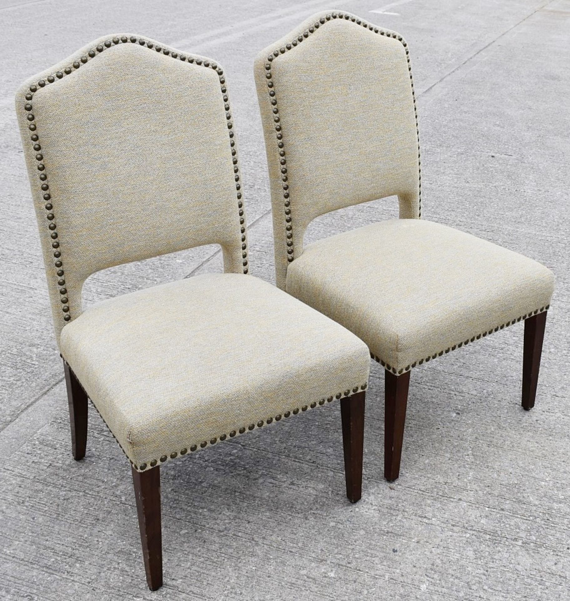 Pair Of Finely Crafted Studded Chairs Upholstered in a Premium Woven Fabric with Wooden Legs -
