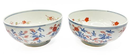 A pair of Chinese bowls, decorated with animals amongst foliage, the inner bowls painted with