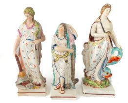 A Staffordshire pearlware figure of Venus, standing beside Cupid and a dolphin, circa 1820, approx