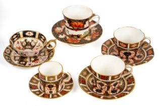 A collection of Royal Crown Derby cups and saucers, including 1283 chocolate cup and saucer, 2451