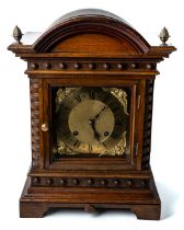 A honey coloured oak bracket clock, glass panelled sides, brass dial with spandrels, acorn