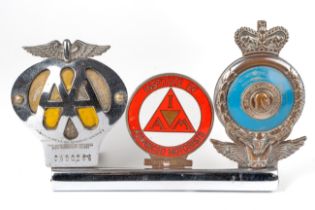 Three car bumper badges, to include AA, IAM and RAC Enamel loss to AA badge, wear to plating