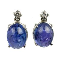 A pair of 18ct white gold tanzanite and diamond stud earrings, set with two oval cabochon tanzanites