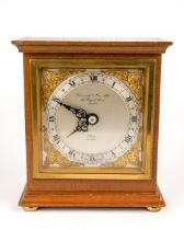 Elliott of London - a giltwood mantel clock, the silvered chapter ring set with Arabic and Roman