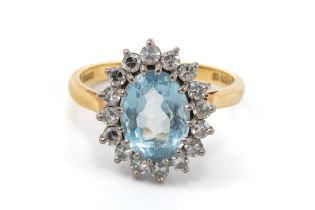 An 18ct yellow gold aquamarine and diamond oval cluster ring, the oval mixed-cut aquamarine